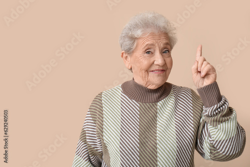 Senior woman pointing at so...