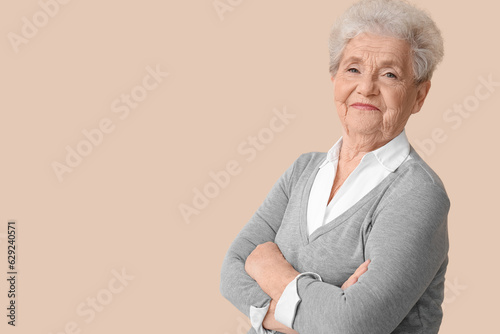 Senior woman on beige background © Pixel-Shot
