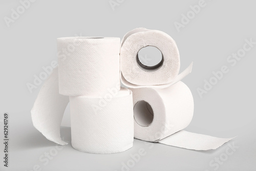 Rolls of toilet paper on grey background