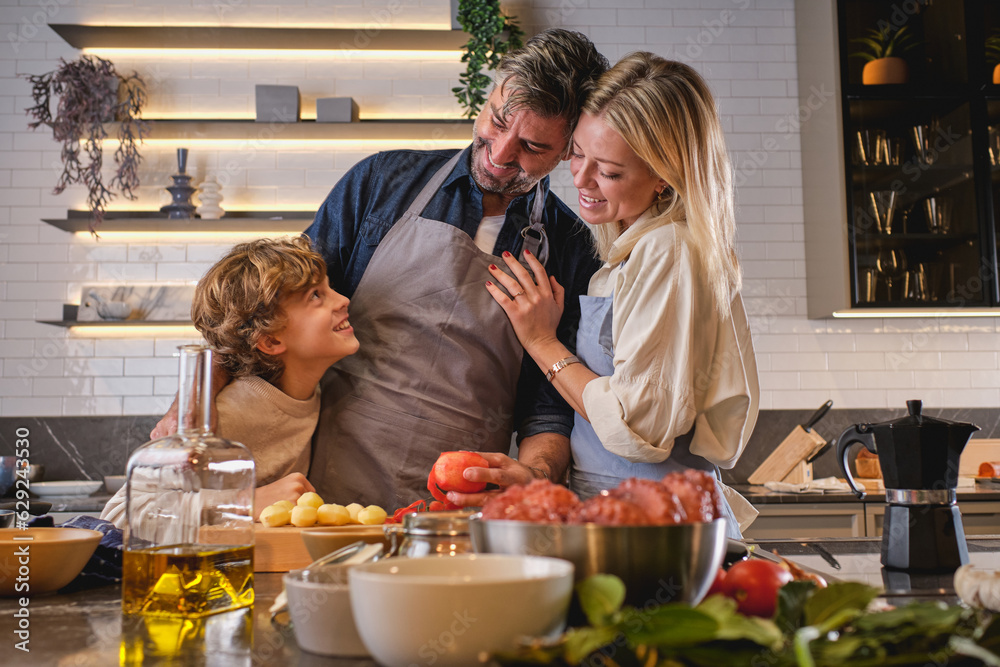 Family cooking in modern kitchen