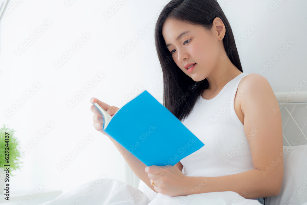 Young asian woman reading a book with relax and cozy on the bed in the bedroom at home, female leisure reading novel while resting with emotional positive, one person, lifestyles concept. Young asian woman reading a book with relax and cozy on the bed in the bedroom at home, female leisure reading novel while resting with emotional positive, one person, lifestyles concept.