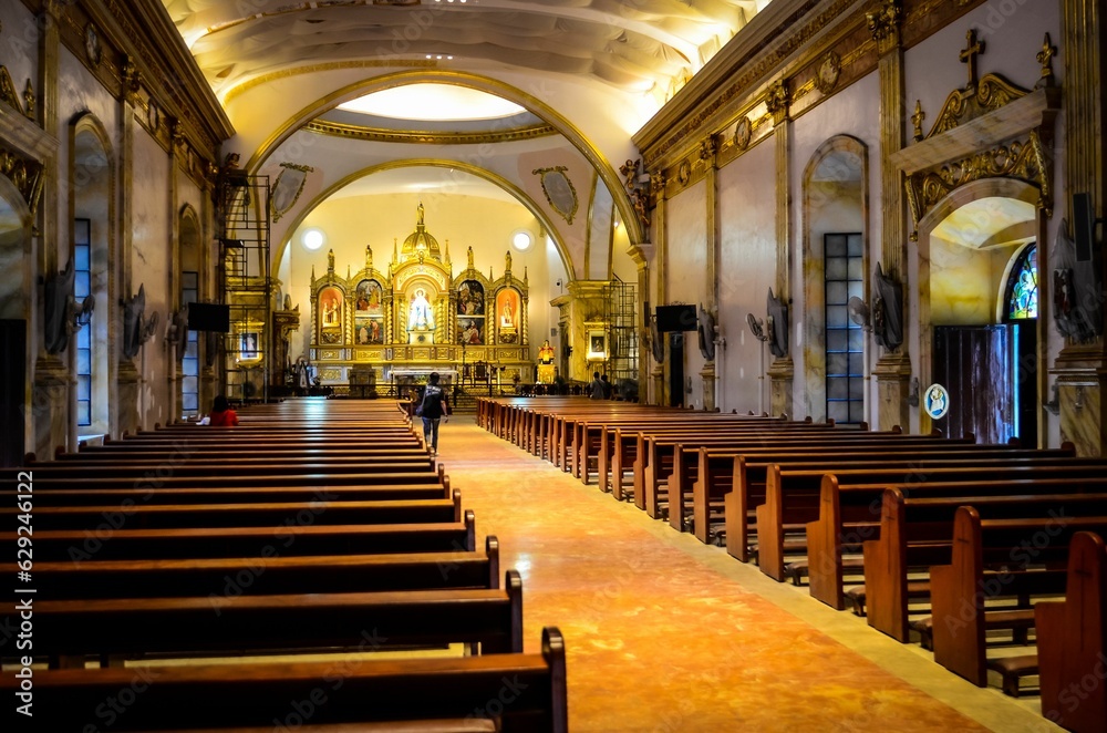 interior shot of an ornate church with pews and walls interior shot of an ornate church with pews and walls