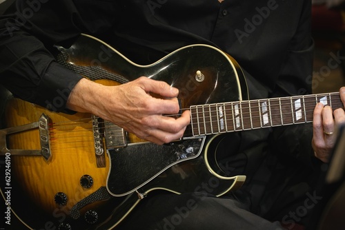Closeup shot of a guitarist playing his guitar.