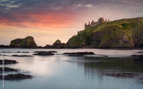 Majestic castle standing proudly on a rocky coast at sunset