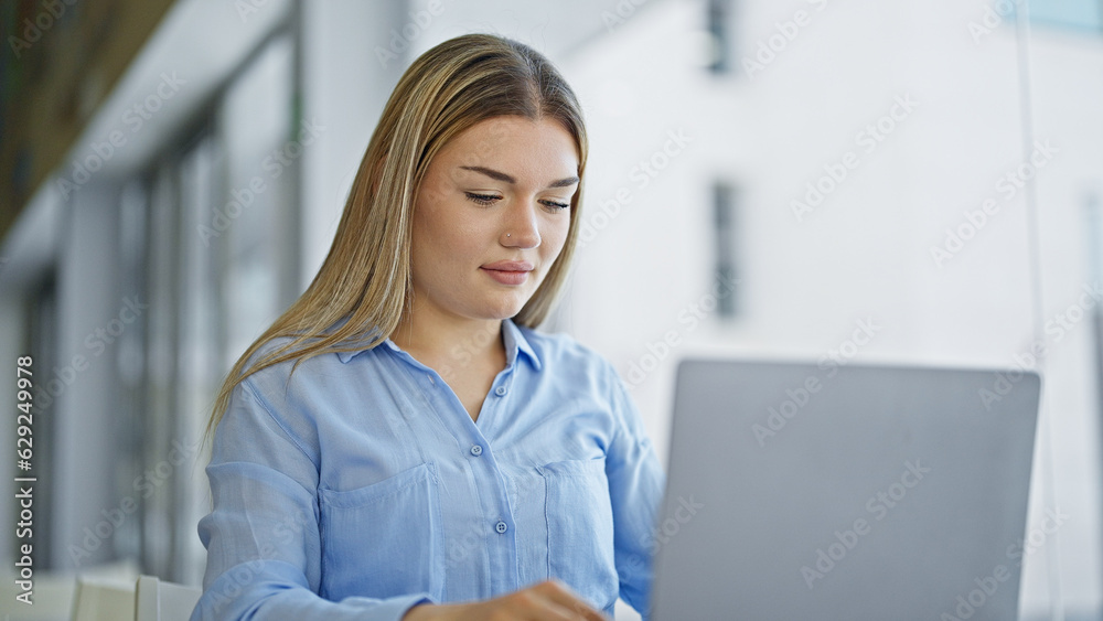 Young blonde woman business worker using laptop working at office Young blonde woman business worker using laptop working at office