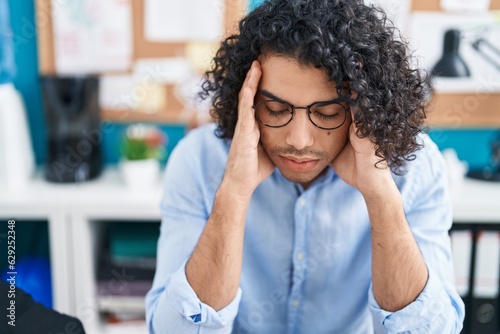 Young latin man business worker stressed at office