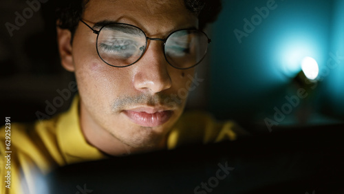 Young latin man business worker using computer working at the office