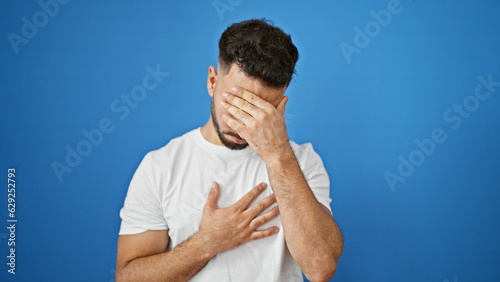 Young arab man being sick coughing over isolated blue background