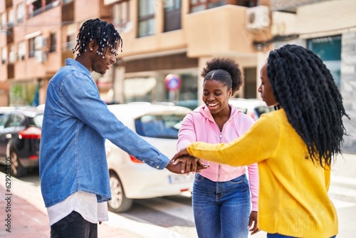 African american friends smiling confident standing with hands together at street