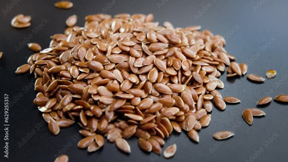 Close-up shot of linseed rotating on a dark background Close-up shot of linseed rotating on a dark background