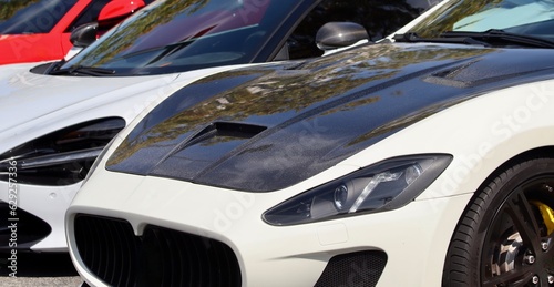 Beautiful sleek car closeup with carbon fiber hood