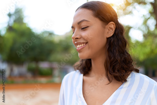 Young african american woman smiling confident looking to the side at park