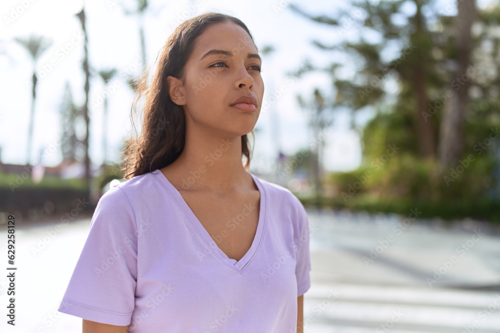 Young african american woman looking to the side with serious expression at street Young african american woman looking to the side with serious expression at street