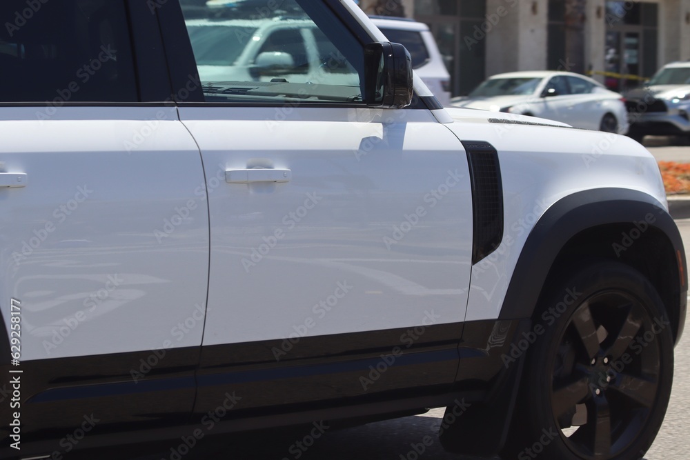 White SUV in motion closeup. Modern new SUV background image.
