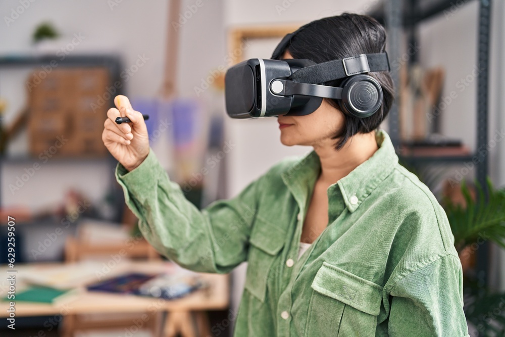 Young chinese woman artist using vr glasses drawing at art studio Young chinese woman artist using vr glasses drawing at art studio