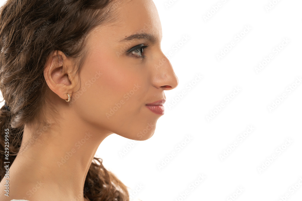 Profile portrait of a beautiful serious young woman, a nose with a hump on white background Profile portrait of a beautiful serious young woman, a nose with a hump on white background