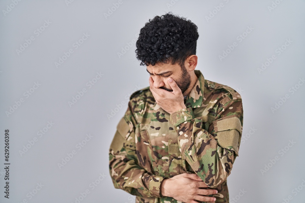 Arab man wearing camouflage army uniform feeling unwell and coughing as symptom for cold or bronchitis. health care concept.