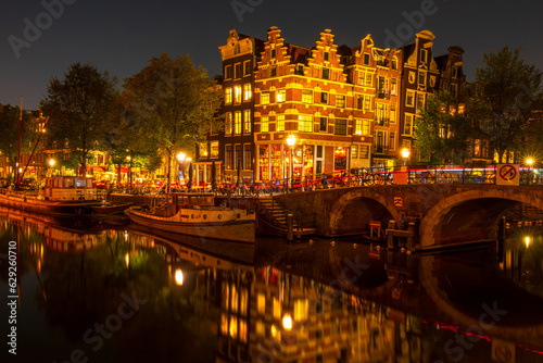 Fototapeta Naklejka Na Ścianę i Meble -  Typical Dutch Houses on the Amsterdam Canal at Night