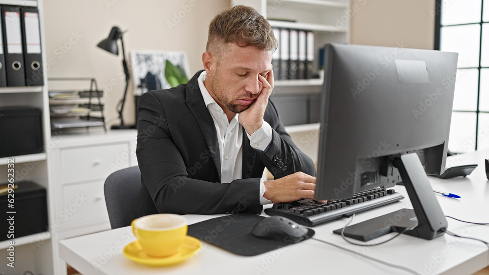 Young man business worker tired using computer working at office