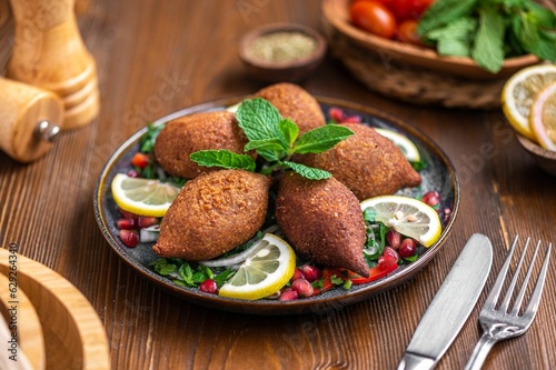 Plate of the Middle Eastern dish, kibbeh with lemons photo