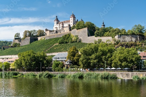 Marienberg Fortress atop a hillside overlooking a tranquil river in Wurzburg, Bavaria, Germany.