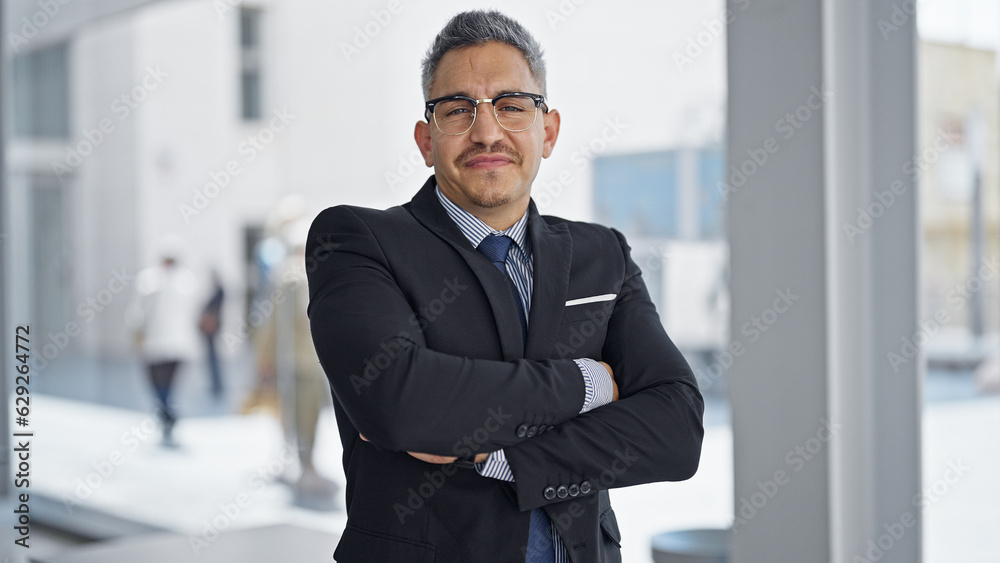 Young hispanic man business worker smiling confident standing with arms crossed gesture at office Young hispanic man business worker smiling confident standing with arms crossed gesture at office