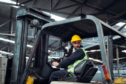 Industrious Engineer Operating Forklift in Warehouse. Efficient Forklift Driving in Factory. Engineer is working and maintaining in the factory.