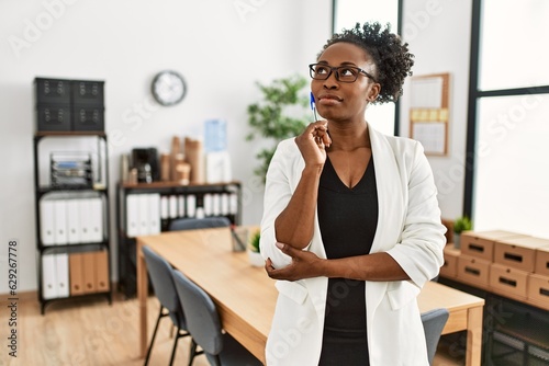 African american woman business worker standing with doubt expression at office