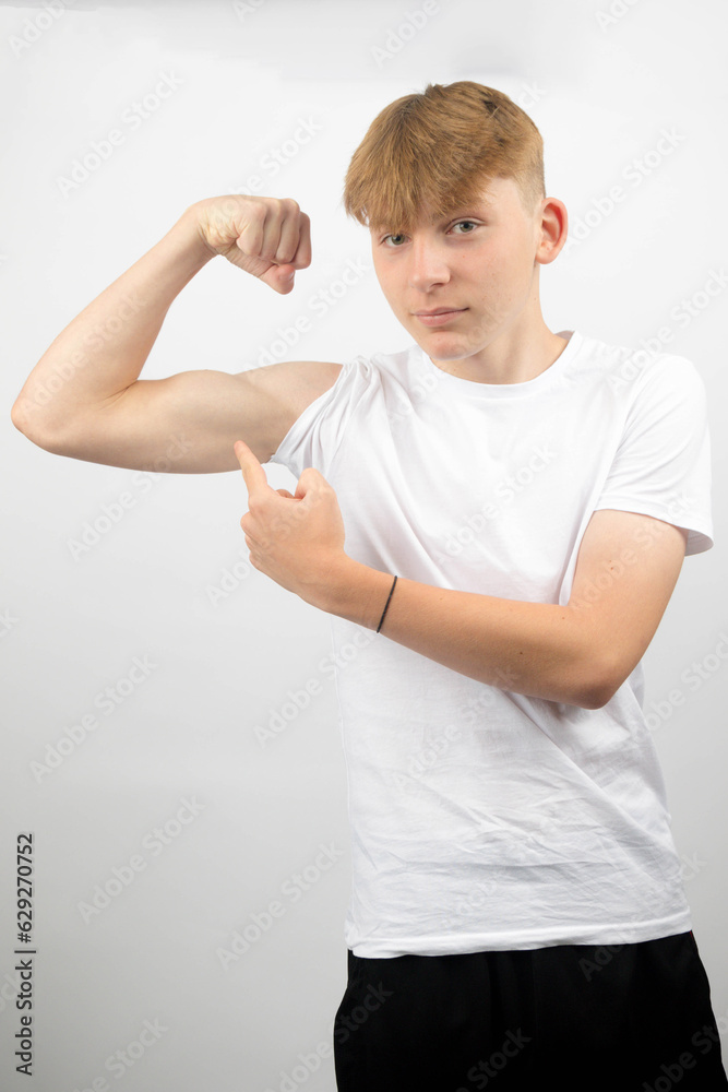 Teenage Boy Flexing His Bicep Teenage Boy Flexing His Bicep