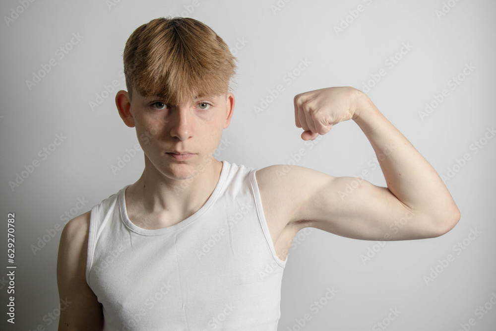 Teenage boy flexing his bicep