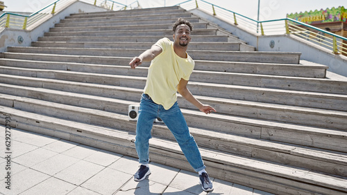 African american man smiling confident dancing at street