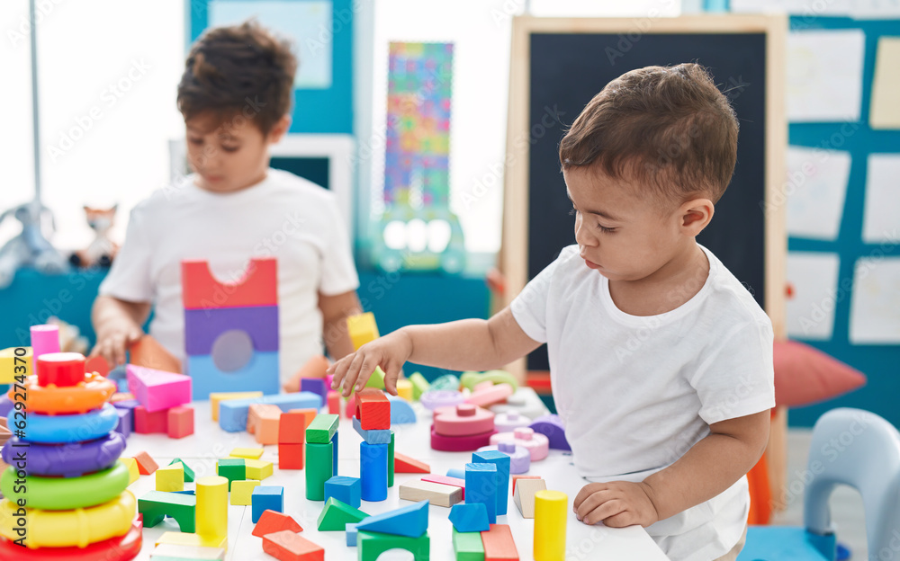 Adorable boys playing with construction blocks at kindergarten Adorable boys playing with construction blocks at kindergarten