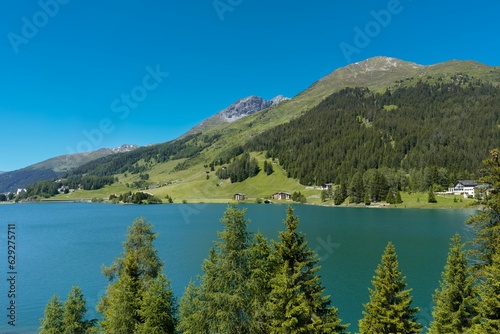 Scenic view of a tranquil lake surrounded by majestic mountain peaks and trees