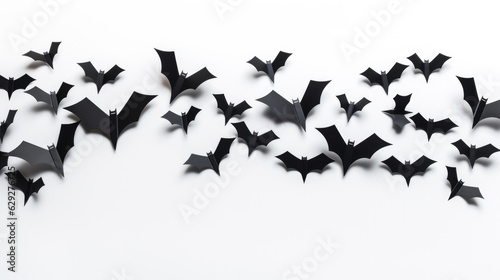 Halloween and decoration concept - black paper bats flying over white background