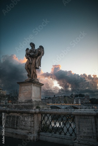 Vertical shot of an angel statue at the St. Angelo Bridge in Rome, Italy