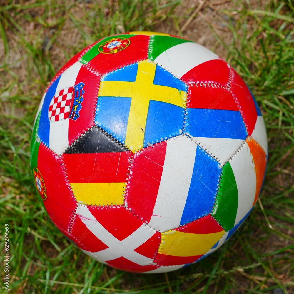 Fototapeta premium Red ball with various international flags on it with an interesting design