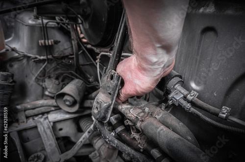Repairing a car engine, close-up of the hands