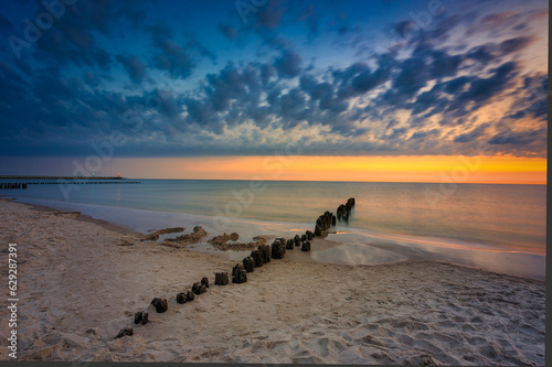 Fototapeta Naklejka Na Ścianę i Meble -  Beautiful sunrise on the summer beach at Baltic Sea in Ustka, Poland.