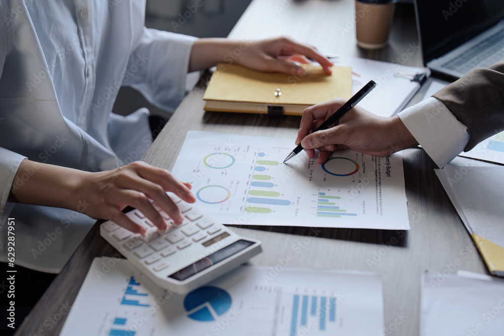 Teamwork of business people discuss and use calculator for finance paperwork data in office