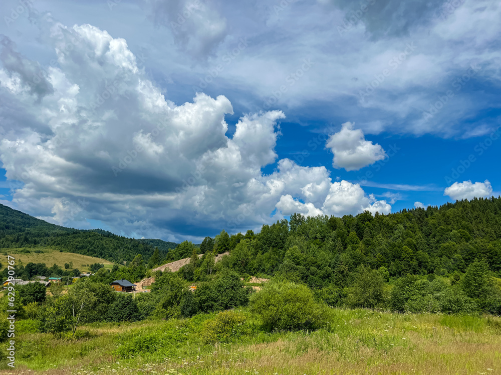 Awesome Carpathian mountains landscape background with forest and clouds on the summer season