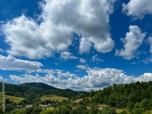 Awesome Carpathian mountains landscape background with forest and clouds on the summer season © zyoma_1986