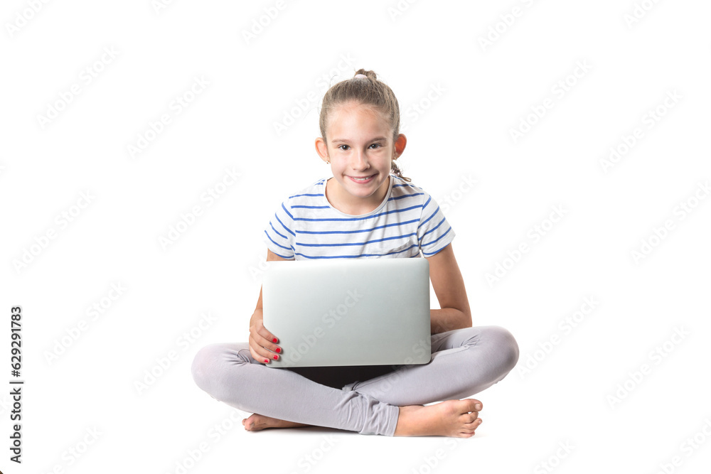 Cute little european smiling girl sitting and working with modern silver laptop isolated on white background Cute little european smiling girl sitting and working with modern silver laptop isolated on white background