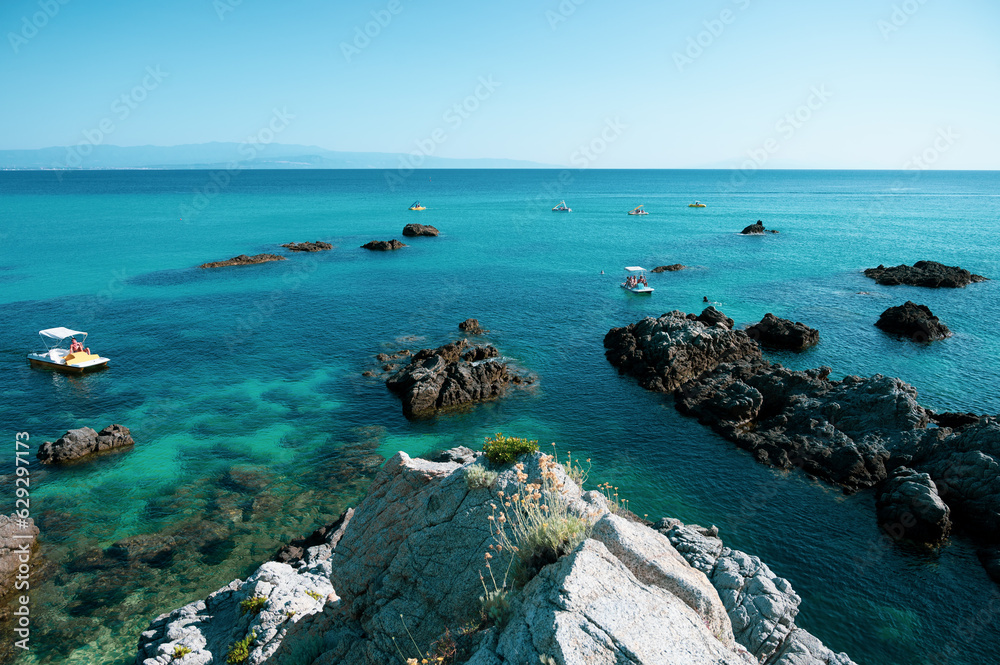 Italy, July 2023: view of the spectacular and relaxing Grotticelle beach near Capo Vaticano in Calabria. You notice the rocks and the bathers having fun during their vacation Italy, July 2023: view of the spectacular and relaxing Grotticelle beach near Capo Vaticano in Calabria. You notice the rocks and the bathers having fun during their vacation