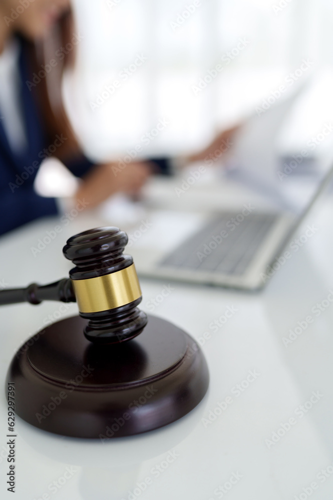 Lawyer preparing to sign a contract and wooden gavel on table justice and law concept