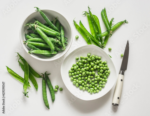 Young fresh green peas on a white background, top view photo