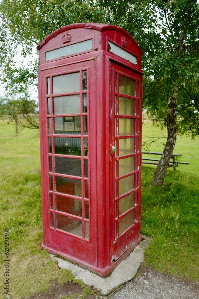 Red British telephone booth in the Highlands open air museum near Aviemore in Scotland Red British telephone booth in the Highlands open air museum near Aviemore in Scotland