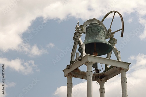 Old church bell standing a background the blue sky, Church Assumption Rosbercon New Ross Ireland. photo