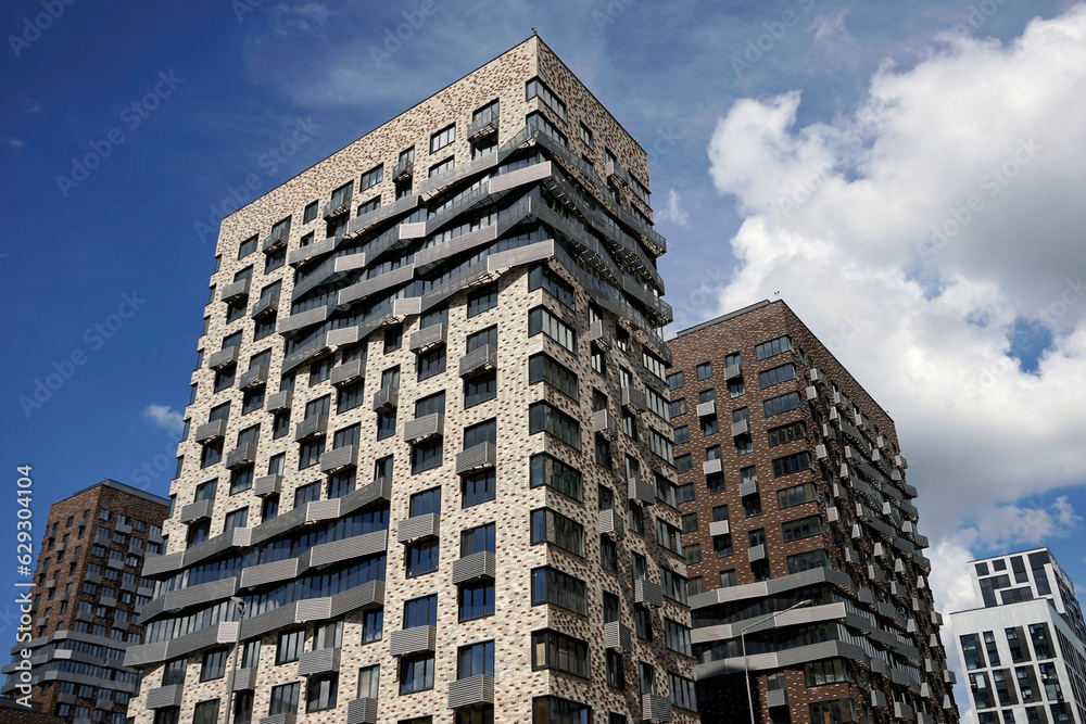 Fototapeta premium New modern residential buildings against the blue sky.