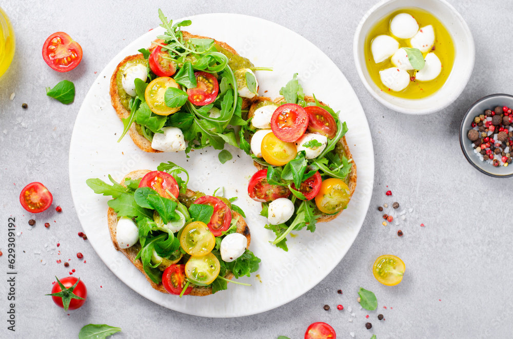 Bruschetta with Cherry Tomatoes, Mini Mozzarella Cheese and Pesto Sauce, Caprese Toasts