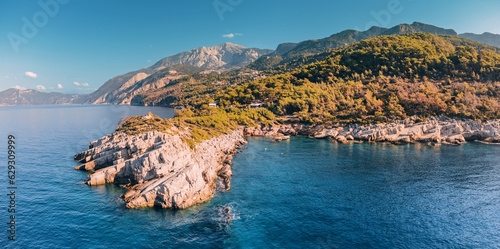 The aerial perspective provides a unique vantage point to appreciate the majestic collision of the rocky coastline and the relentless waves of the Aegean Sea. photo